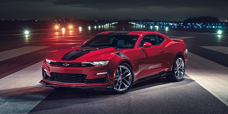 Side view of a 2024 Chevrolet Camaro in the color red with black accents